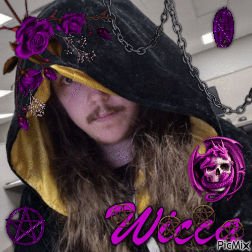 A man with long brown hair, one eye peeking out from behind a hooded black robe.